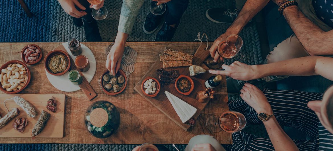 top view of a group of people around a table enjoying food and f